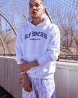 Man wearing a white hoodie and RF-Wear Men's Mesh Flame Shorts in White/Grey
