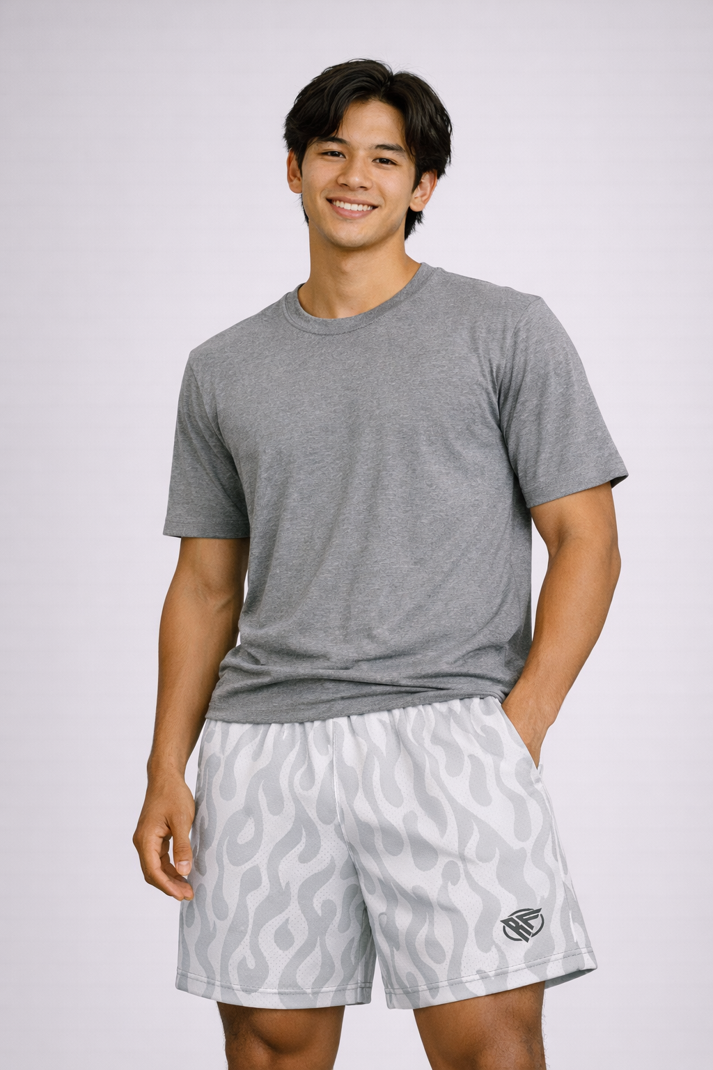 Man wearing a short sleeve grey top and RF-Wear Men's Mesh Flame Shorts in White/Grey