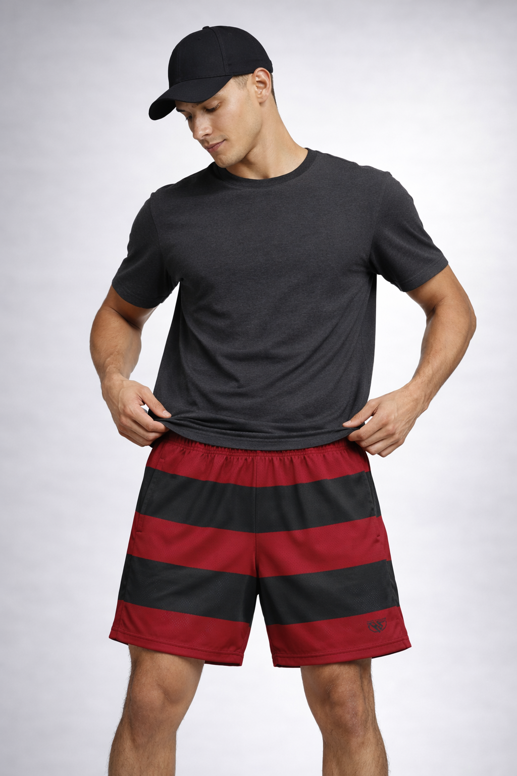 Woman wearing a dark grey t-shirt, ball cap, and RF-Wear Men's Mesh Horror Freddy Shorts in Red/Green