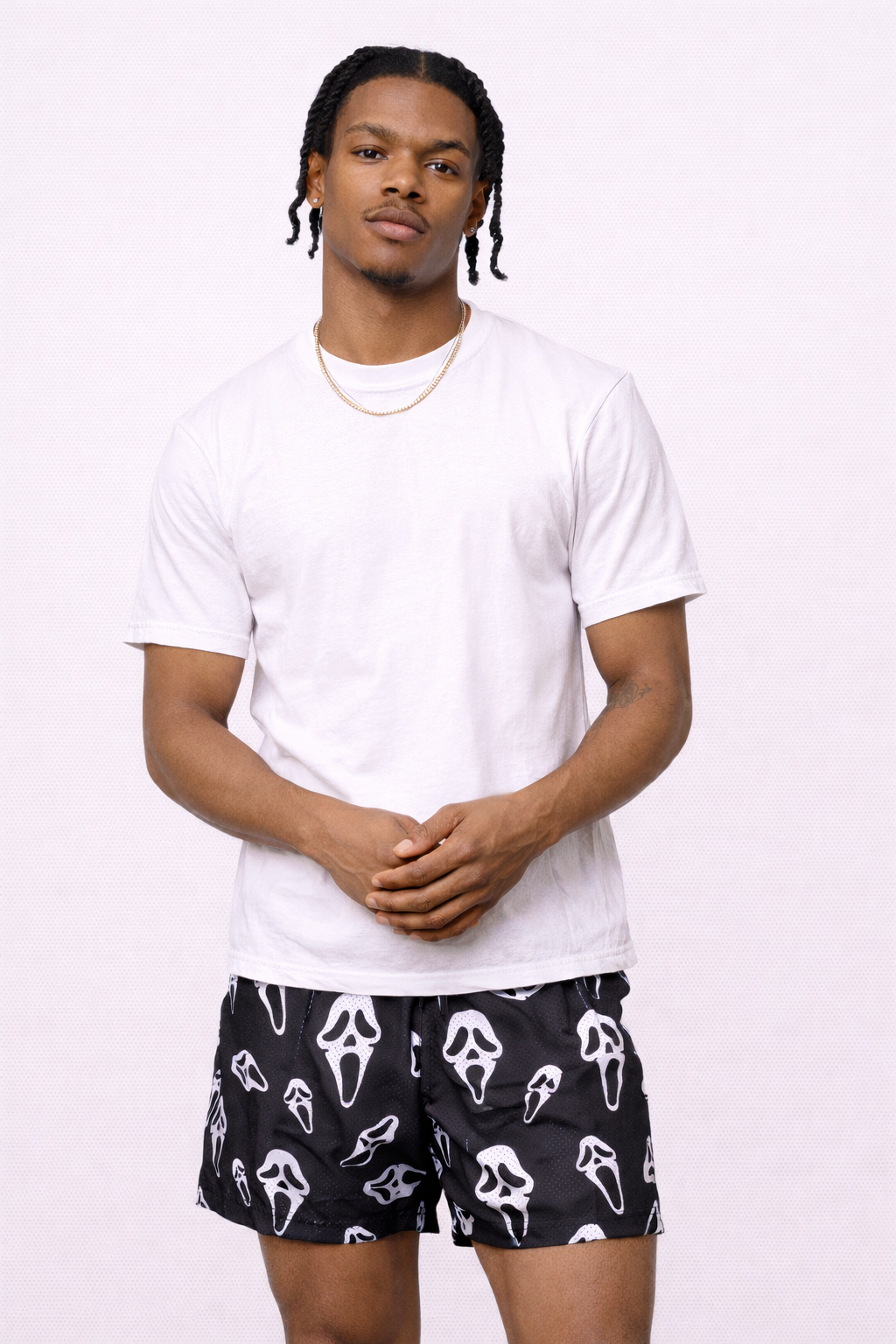 Man wearing a white t-shirt and RF-Wear Men's Mesh Ghost Faces Shorts in Black