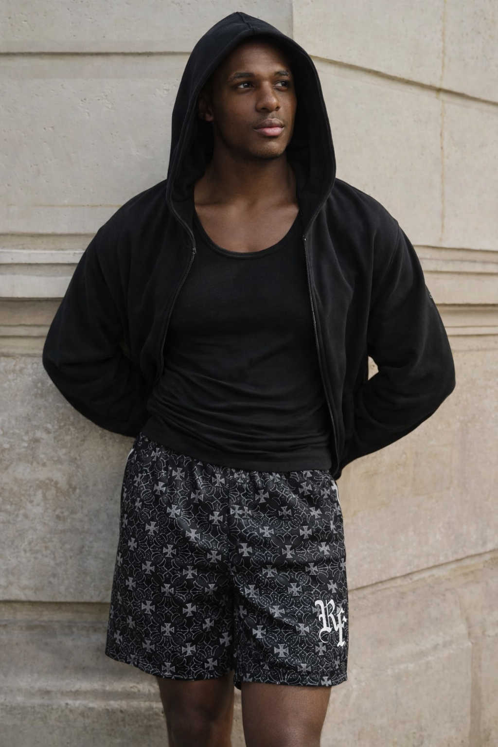 Man wearing a black hoodie and RF-Wear Men's Mesh Gothic Cross Shorts in Black/Grey