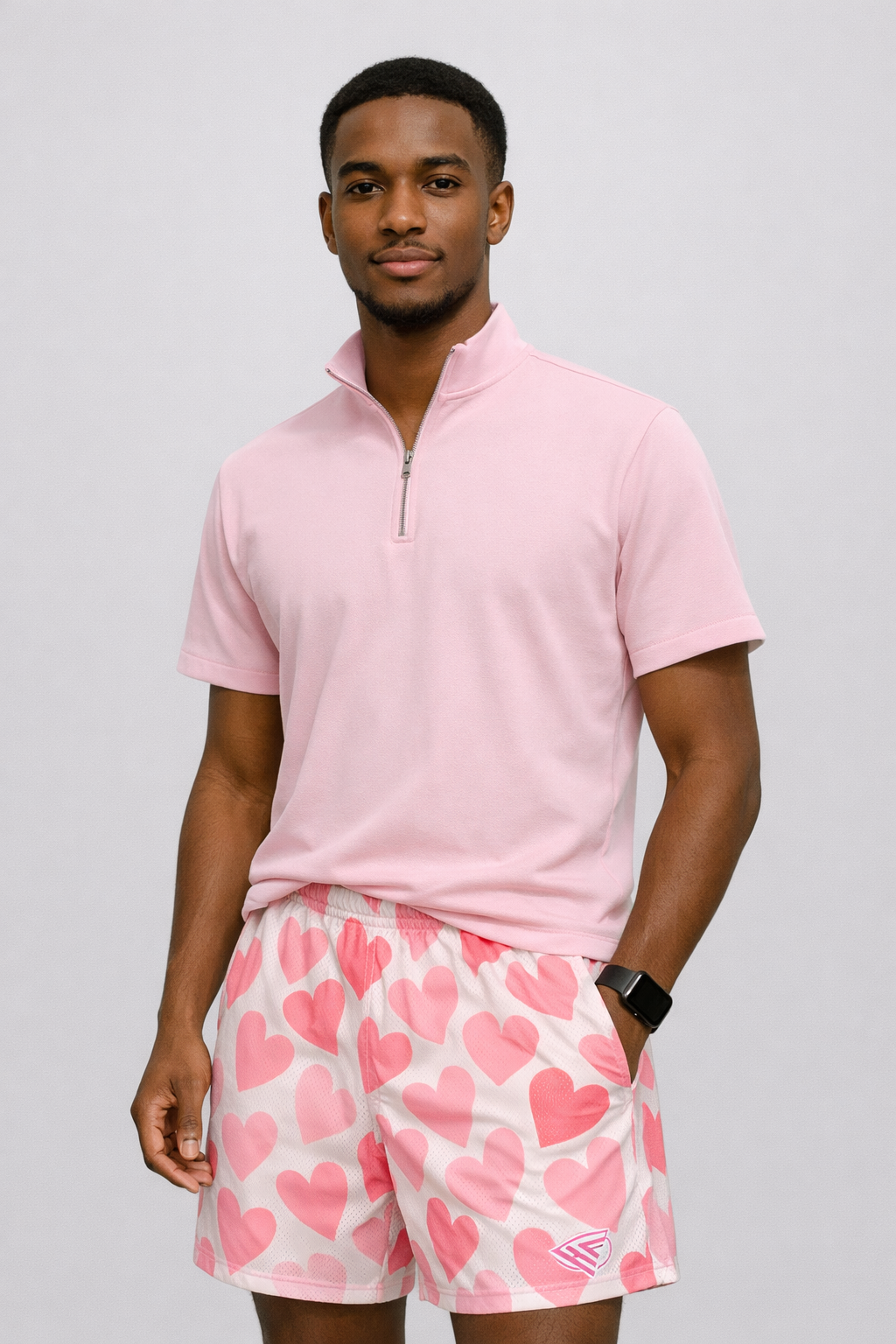Man wearing a short sleeve quarter zip and RF-Wear Men's Mesh Heart Shorts in White/Pink
