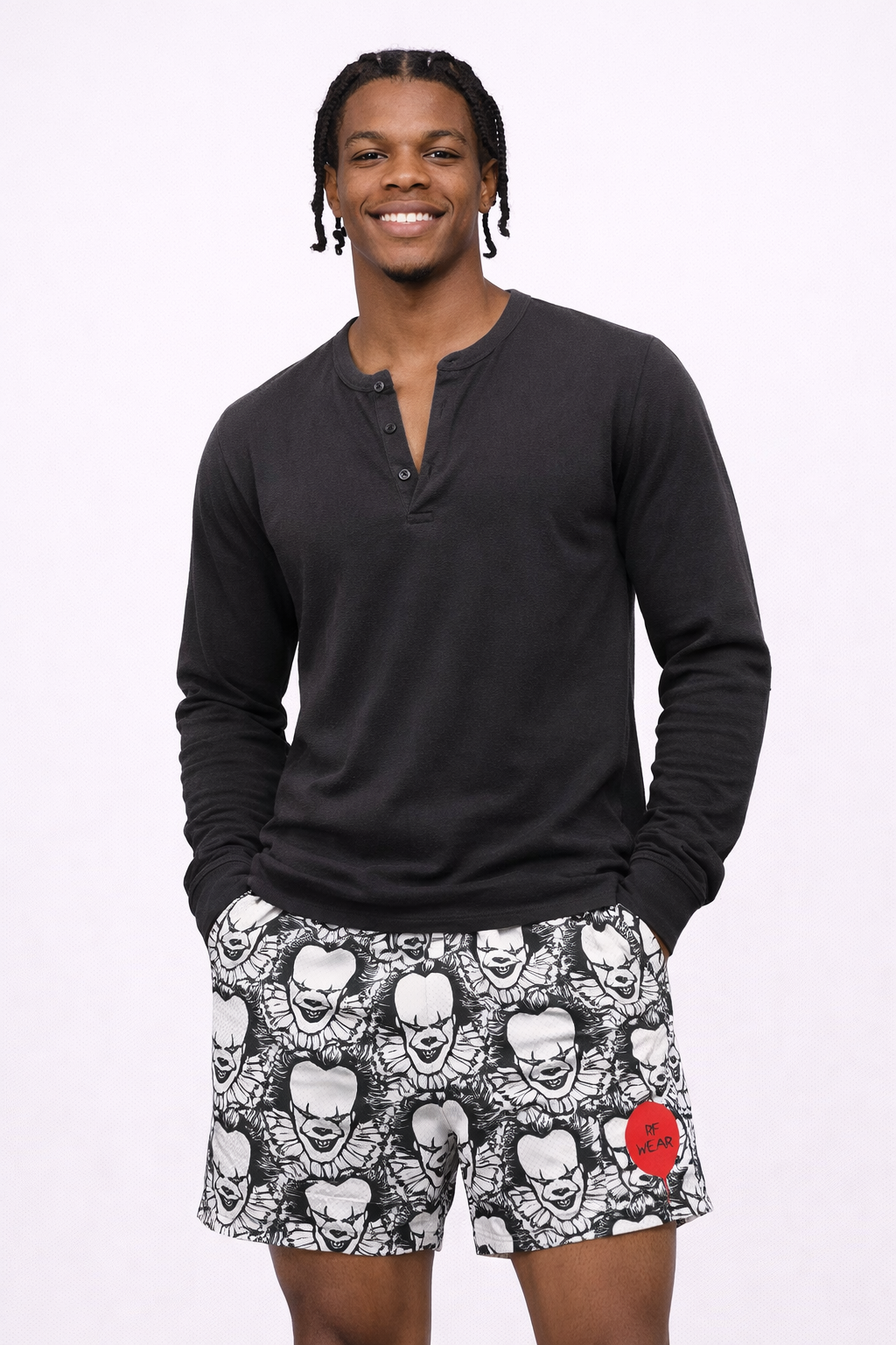 Man wearing a black long sleeve shirt and RF-Wear Men's Mesh Horror Clown Shorts in Black/White