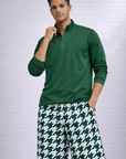 Man wearing a green long sleeve quarter zip top and RF-Wear Men's Mesh Houndstooth Shorts in Green/White