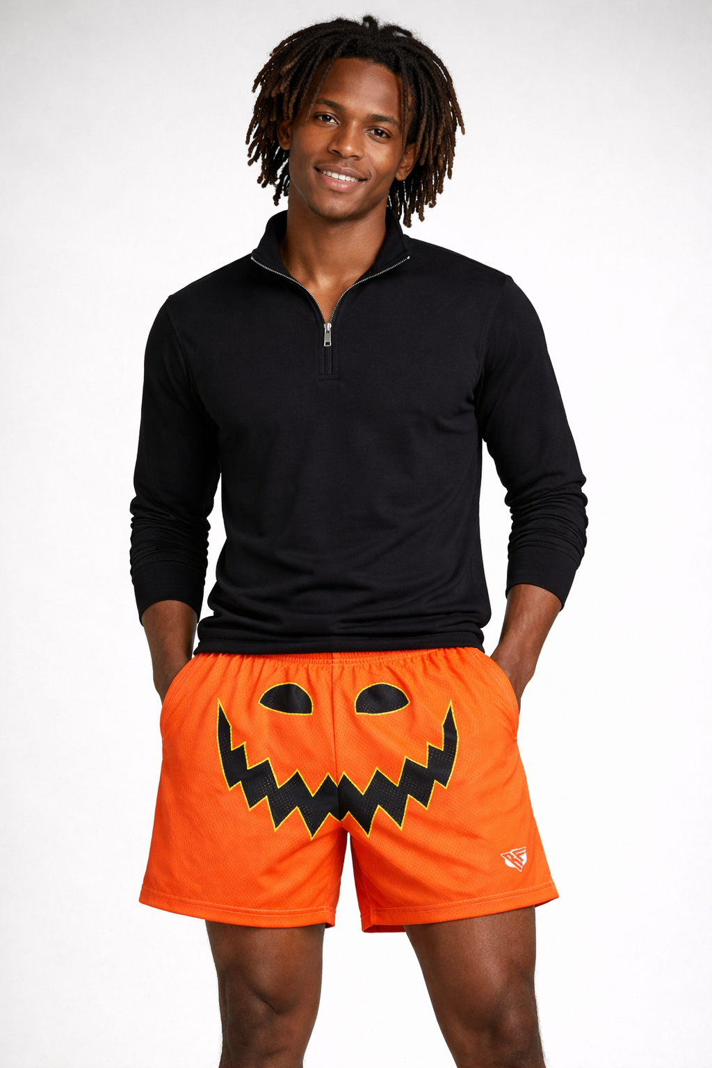 Man wearing a black quarter zip and RF-Wear Men's Mesh Jack-O-Lantern Face Shorts in Orange/Black 