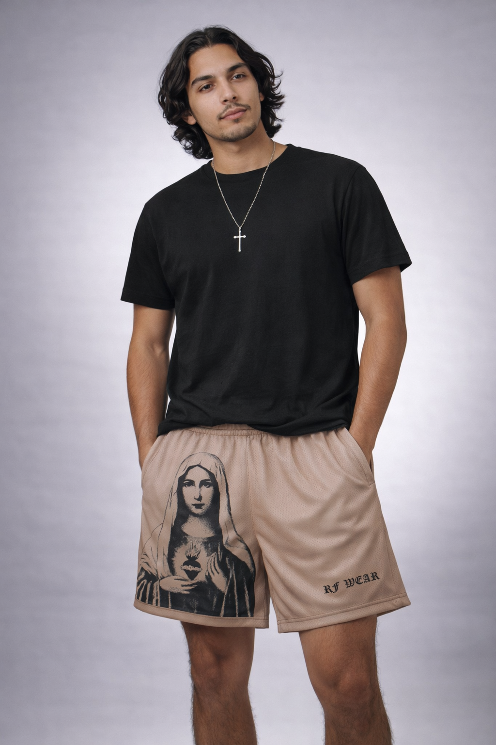 Man wearing a black t-shirt and RF-Wear Men's Mesh Mary Shorts in Tan