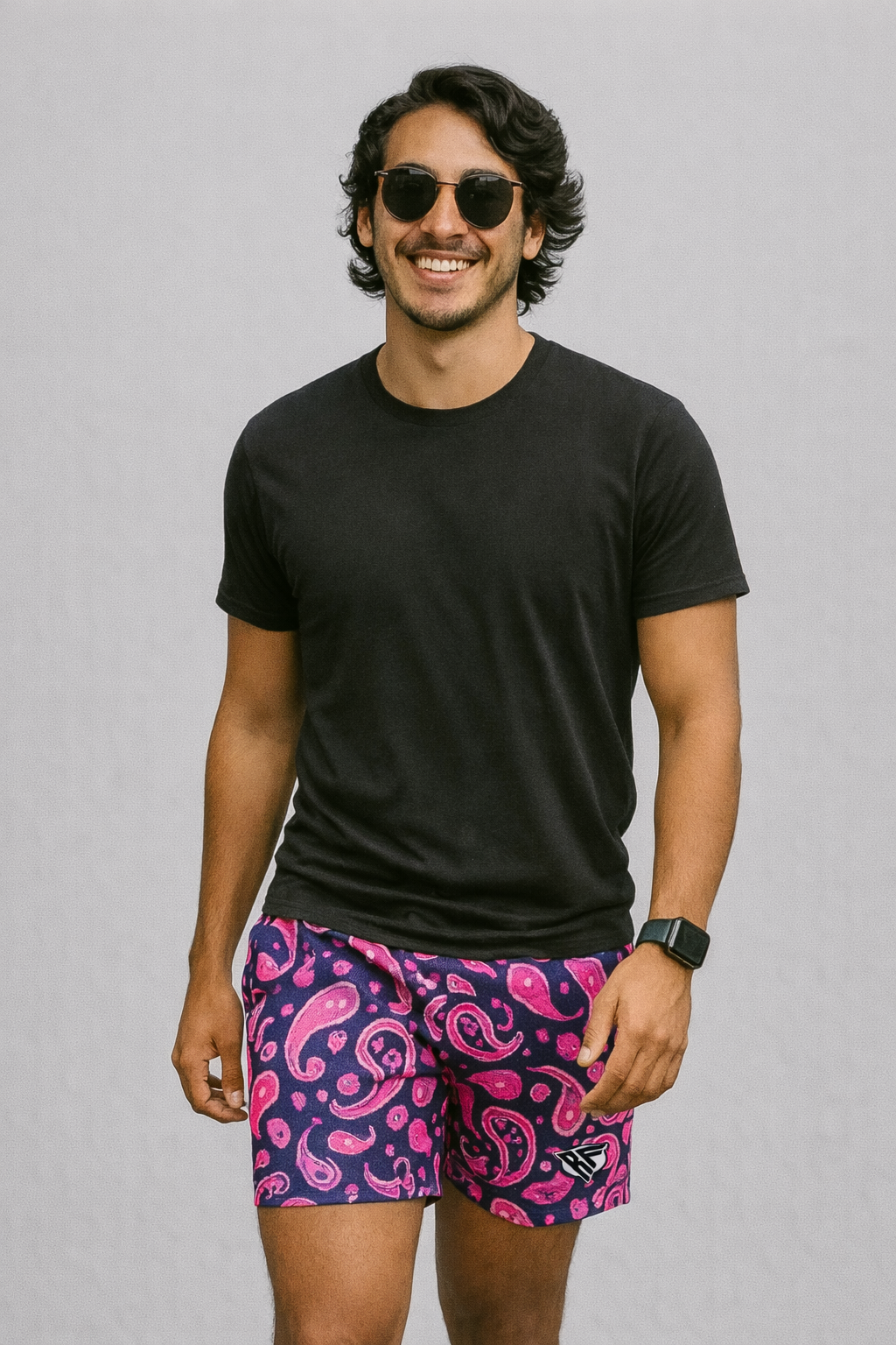 Man wearing a black t-shirt and RF-Wear Men's Mesh Paisley Shorts in Black/Pink