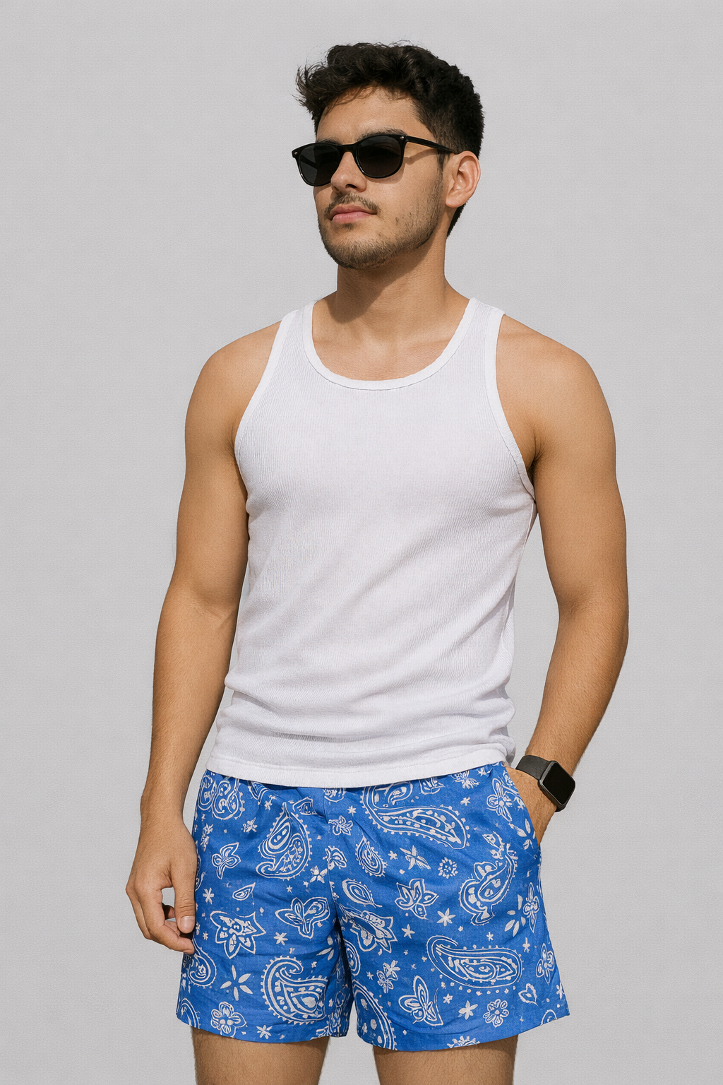 Man wearing a white tank top and RF-Wear Men's Mesh Paisley Shorts in Blue/White 