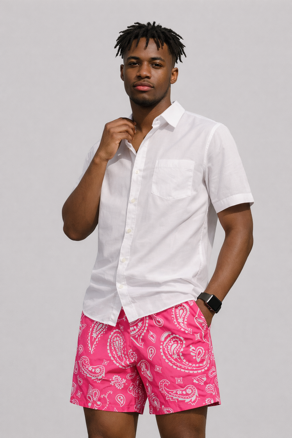 Man wearing a white shirt and RF-Wear Men's Mesh Paisley Shorts in Fuchsia/White