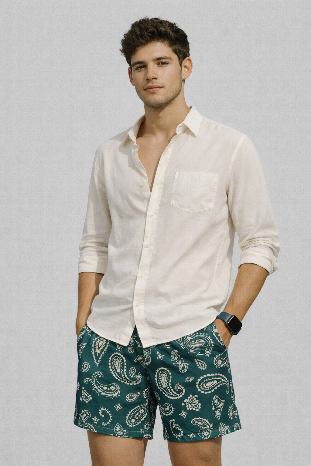 Man wearing a cream shirt and RF-Wear Men's Mesh Paisley Shorts in Pine-Green/Cream