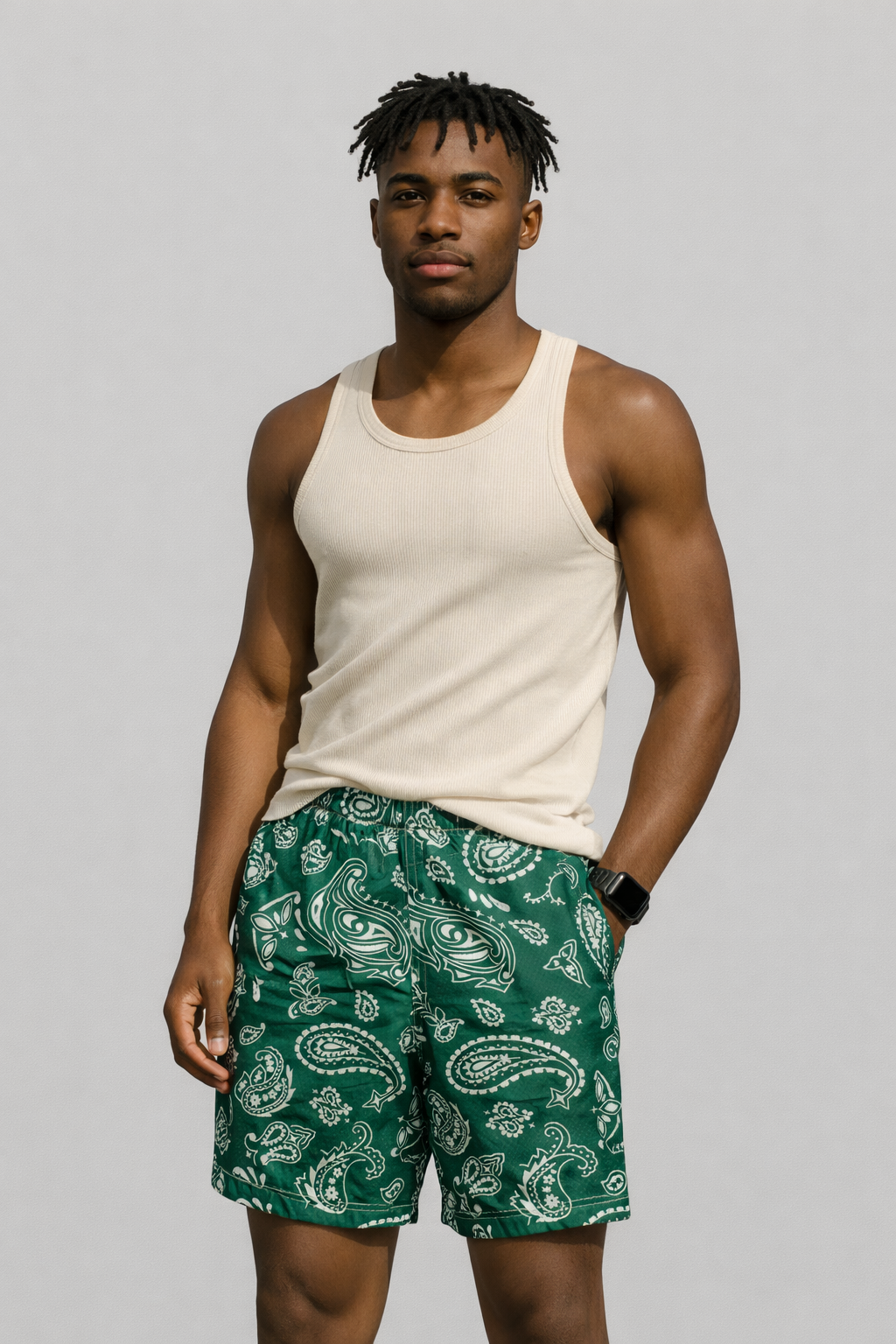 Man wearing a tank top and RF-Wear Men's Mesh Paisley Shorts in Green/White 