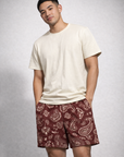 Man wearing a cream t-shirt and RF-Wear Men's Mesh Paisley Shorts in Merlot/Cream