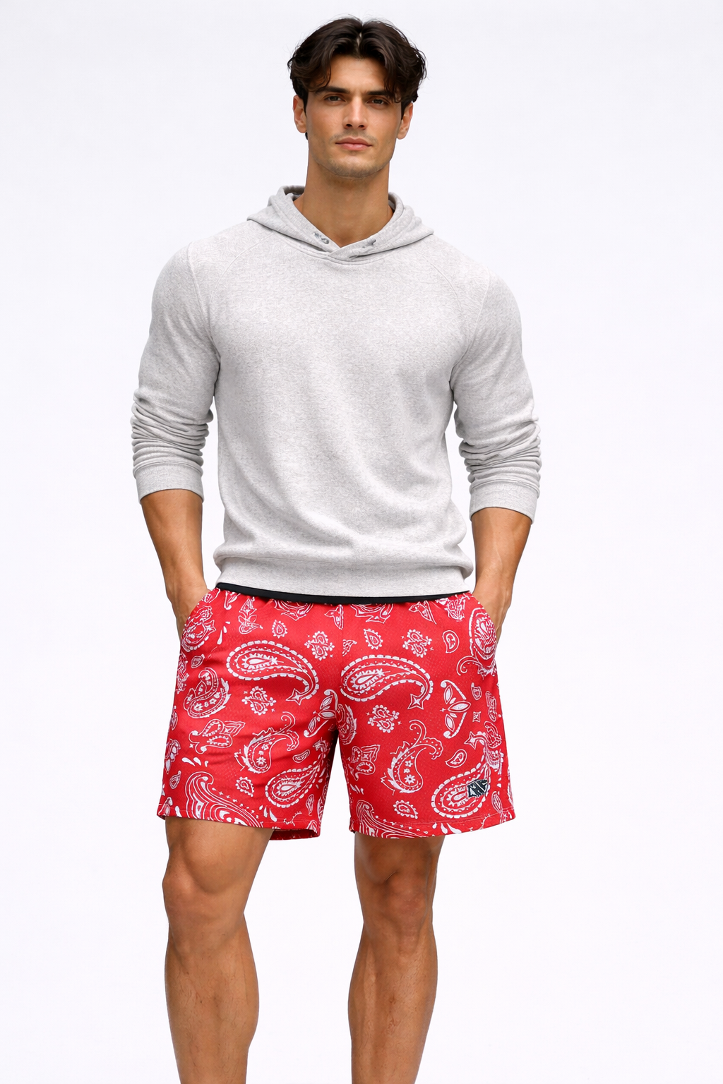 Man wearing a white hoodie and RF-Wear Men's Mesh Paisley Shorts in Red/White 
