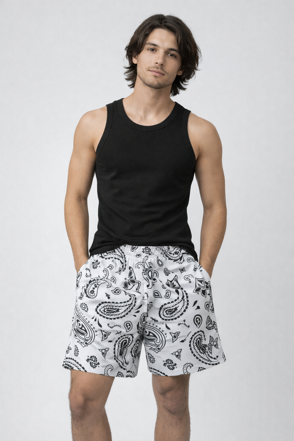 Man wearing a black tank top and RF-Wear Men's Mesh Paisley Shorts in White/Black 