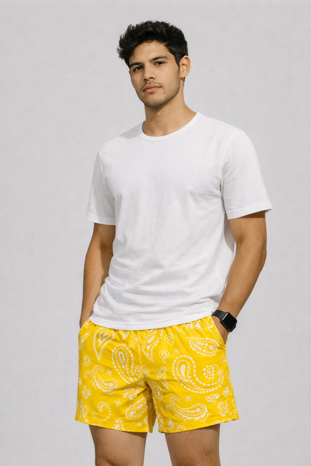 Man wearing a white t-shirt and RF-Wear Men's Mesh Paisley Shorts in Yellow/White