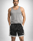Man wearing a grey tank top and RF-Wear Men's Mesh Pinstripe Basketball Shorts in Black/White