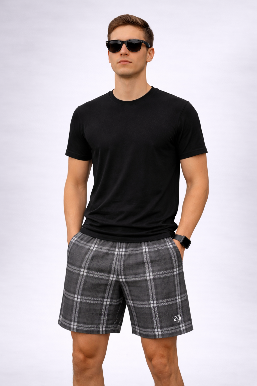 Man wearing a black t-shirt and RF-Wear Men's Mesh Plaid Shorts in Charcoal 