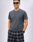 Man wearing a grey t-shirt and RF-Wear Men's Mesh Tartan Plaid Shorts in Navy