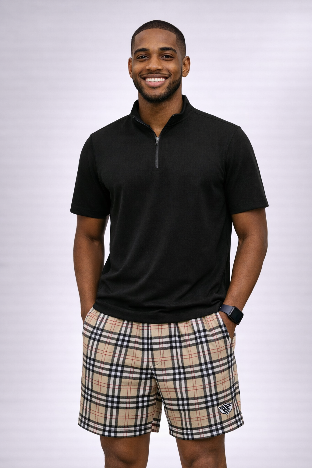 Man wearing a short sleeve black quarter zip top and RF-Wear Men's Mesh Tartan Plaid Shorts in Tan/Black