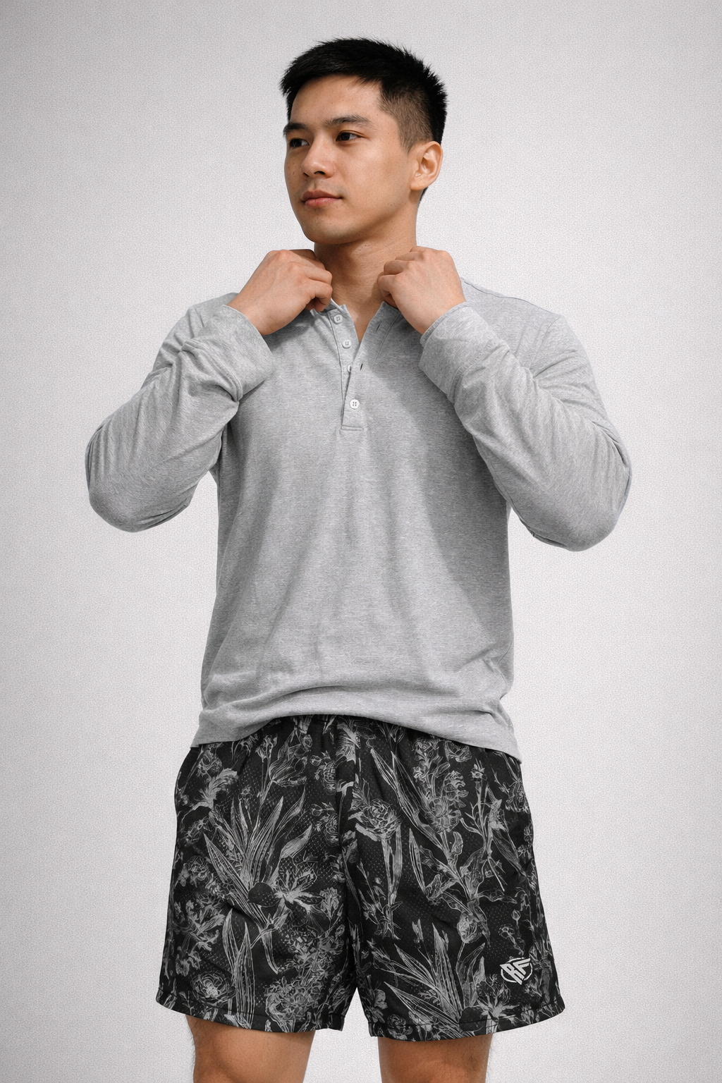 Man wearing a grey long sleeve shirt and RF-Wear Men's Mesh Floral Porcelain Shorts in Black/Grey 