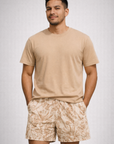 Man wearing a tan t-shirt and RF-Wear Men's Mesh Floral Porcelain Shorts in Cream/Tan 