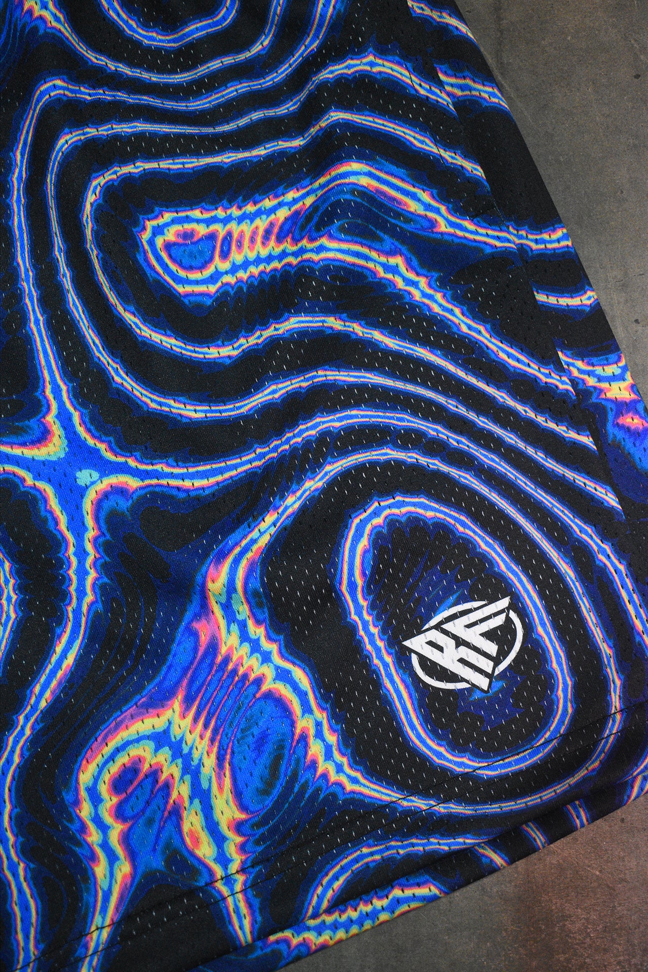 Close-up of RF-Wear Men's Mesh Psychedelic Shorts in Black/Multicolor with RF Logo