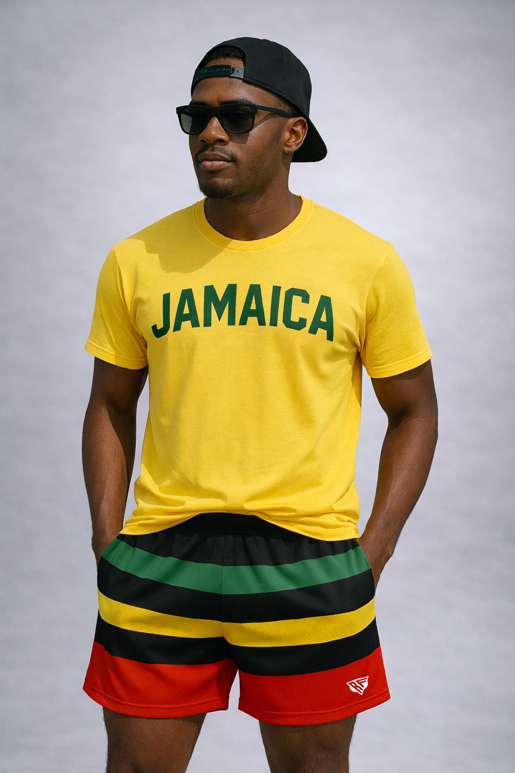 Man wearing a yellow t-shirt with JAMAICA written on the front and RF-Wear Men's Mesh Rasta Shorts in multicolors