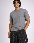Man wearing a grey t-shirt and RF-Wear Men's Mesh Reflective Barb Wire Shorts in Black