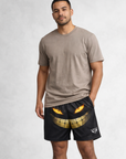 Man wearing a taupe short sleeve t-shirt and RF-Wear Men's Mesh Sinister Smile Shorts in Black
