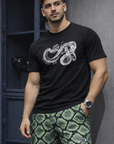 Man wearing a black t-shirt and RF-Wear Men's Mesh Snakeskin Shorts in Green