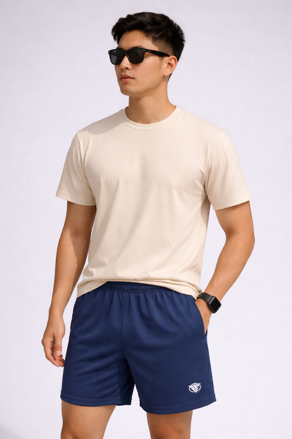 Man wearing a natural colored t-shirt and RF-Wear Men's Mesh Solid Color Shorts in Navy