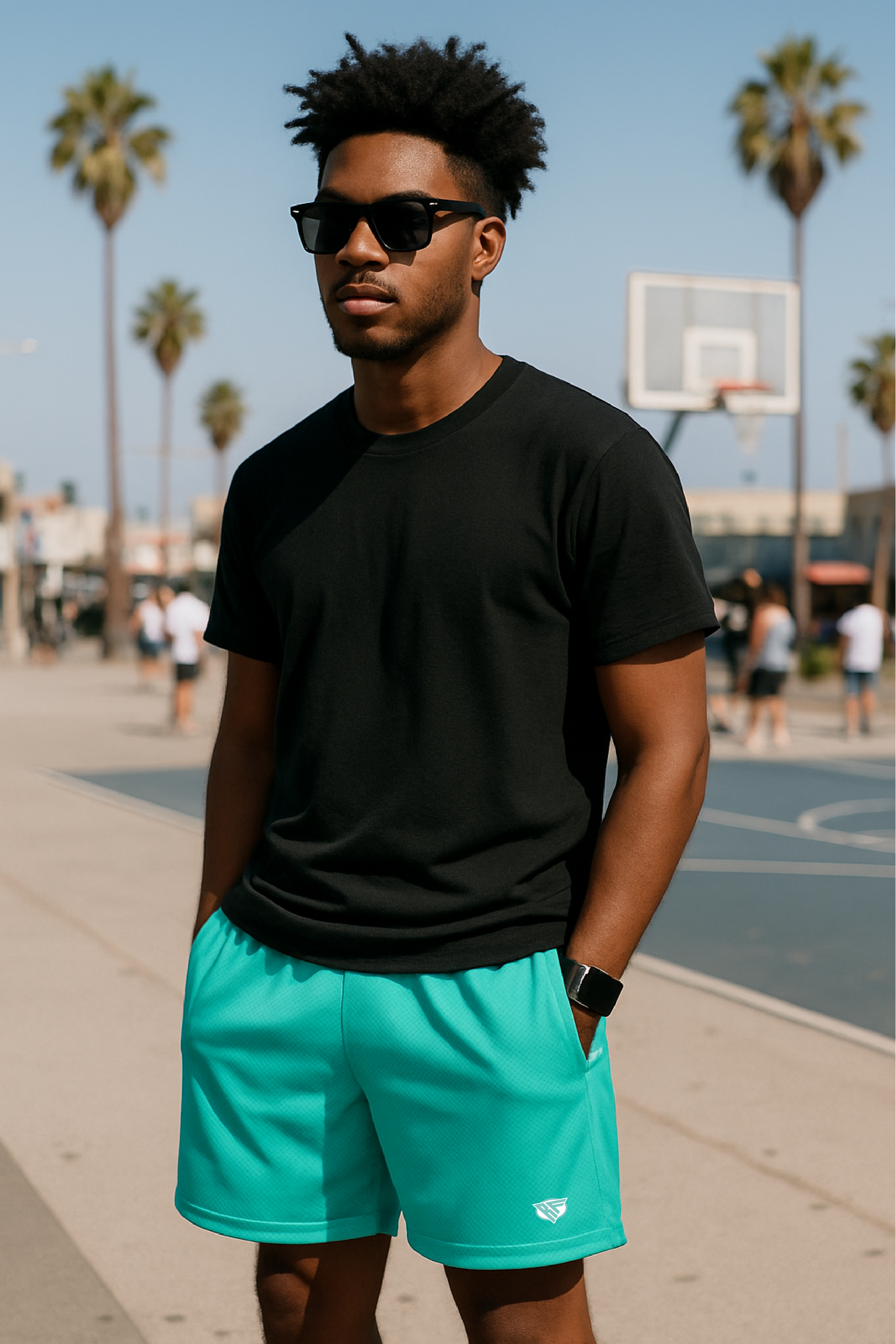 Man wearing a black t-shirt and RF-Wear Men's Mesh Solid Color Shorts in Teal  near basketball court