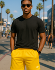 Man wearing a black t-shirt and RF-Wear Men's Mesh Solid Color  Shorts in Yellow