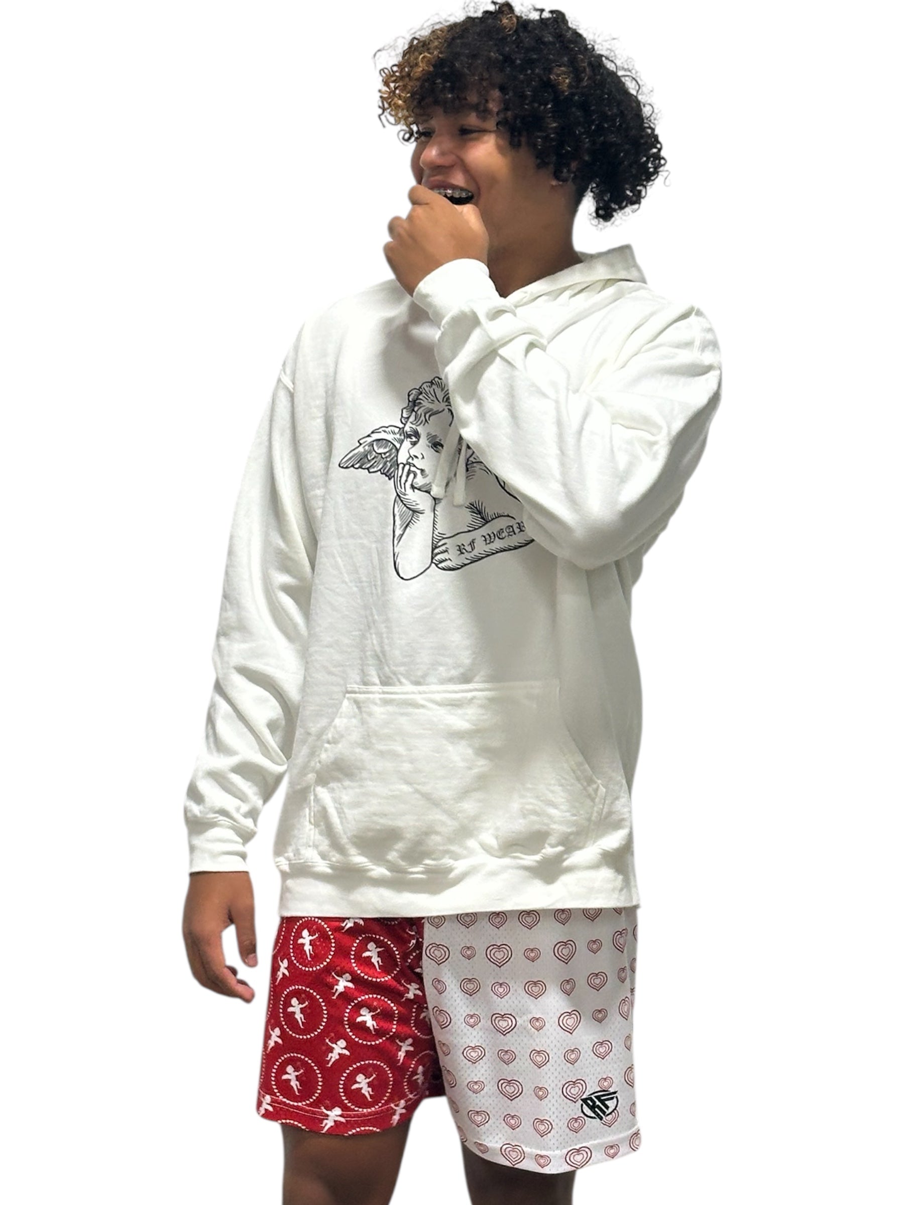 Man wearing a white graphic cherub hoodie and RF-Wear split cupid heart shorts.