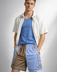 Man wearing a blue tank top with a shite open front dress shirt and RF-Wear Men's Mesh Split Porcelain on the Side Shorts in Blue-Finch/Incense