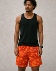 Man wearing a black tank top and RF-Wear Men's Mesh Star Shorts in Red/Orange 