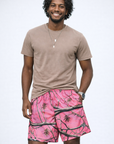 Man wearing a t-shirt and RF-Wear Men's Mesh Tree Camo Shorts in Pink