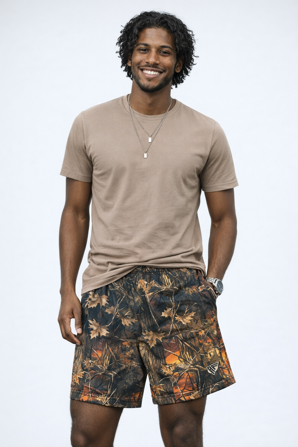 Man wearing a t-shirt and RF-Wear Men's Mesh Tree Camo Shorts in Sunset