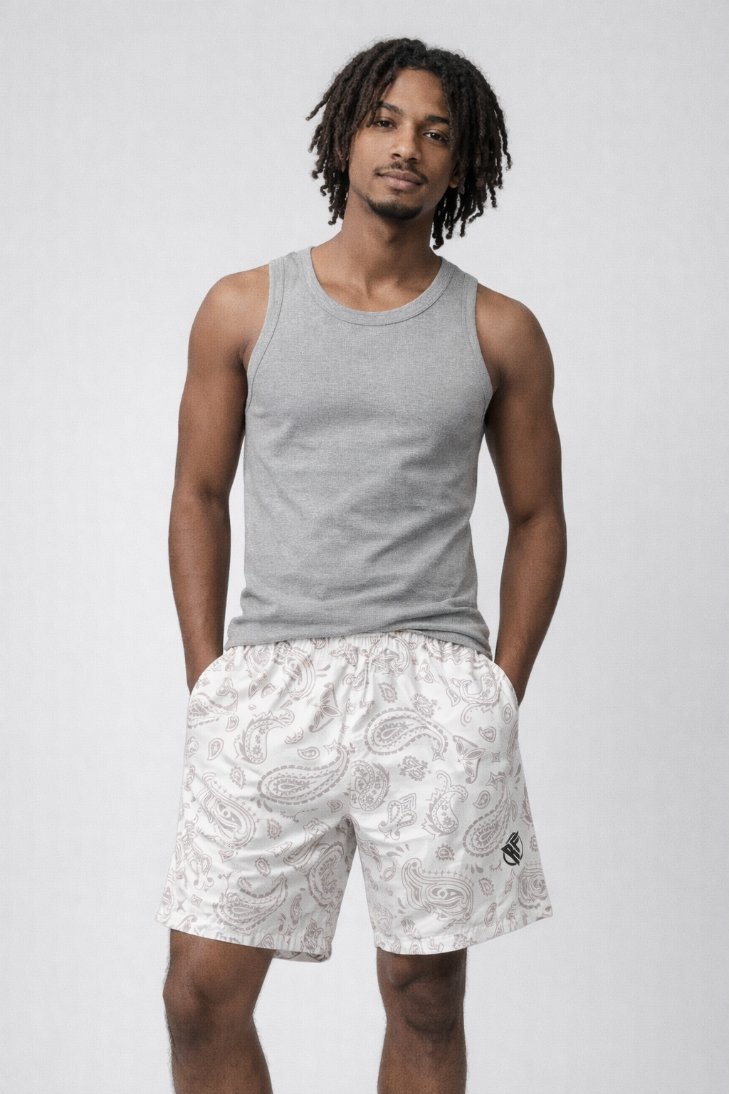 Man wearing a grey tank top and RF-Wear Men's Paisley Shorts in Cream/Grey 
