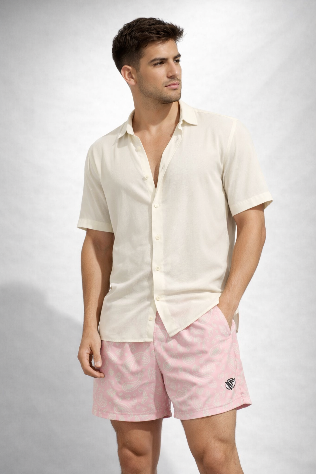 Man wearing a cream shirt and RF-Wear Men's Paisley Shorts in Pink/Cream