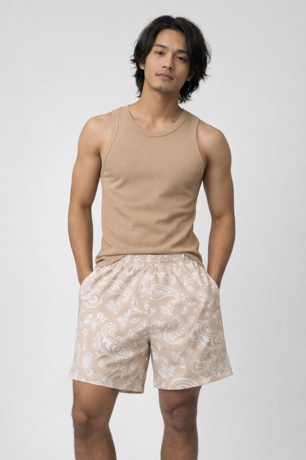 Man wearing a tan tank top and RF-Wear Men's  Paisley Shorts in Tan/White 