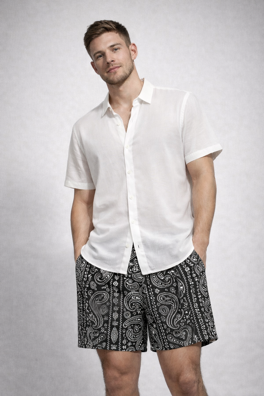 Man wearing a white shirt and RF-Wear Men's Paisley Stripe Shorts in Black