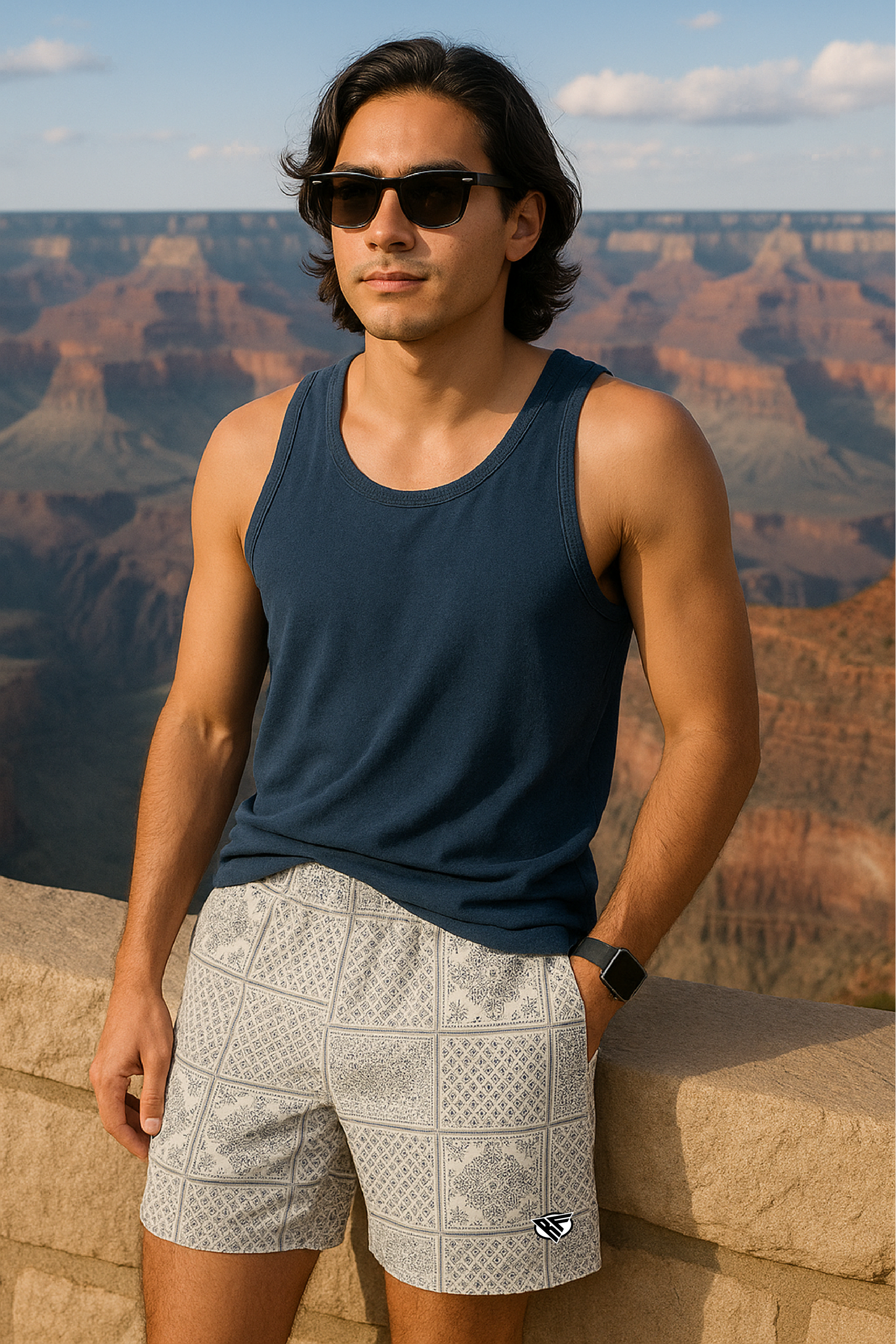 Man wearing a navy tank top and RF-Wear Men's Bandana Patchwork Shorts in Cream/Grey with Grand Canyon in background.