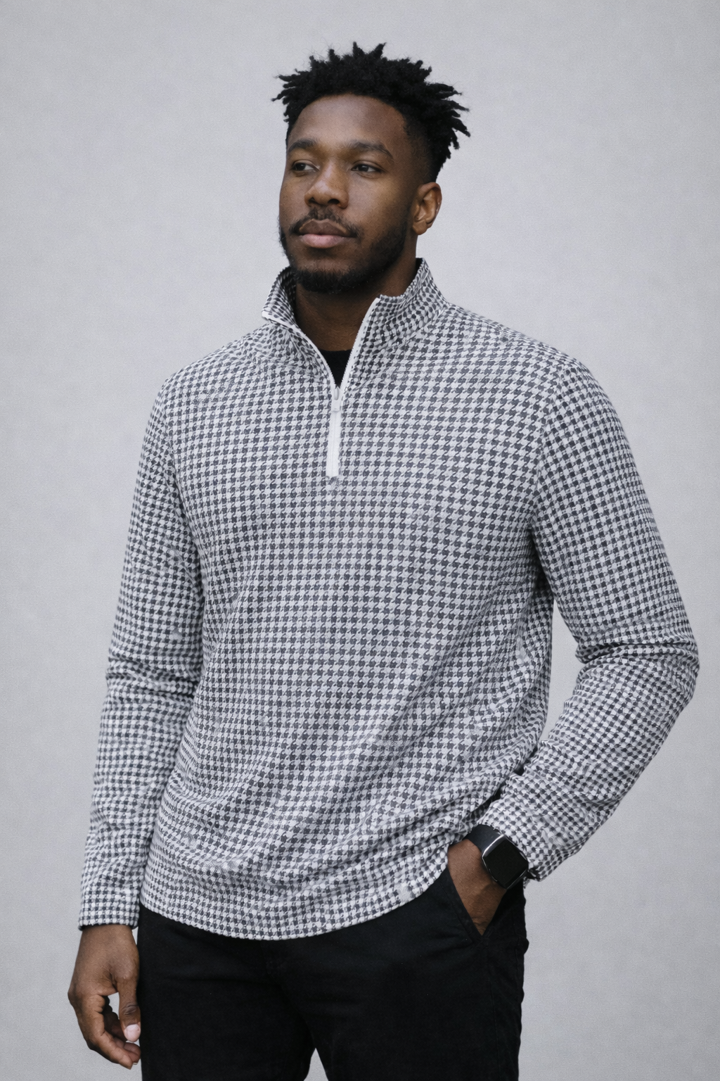 Man wearing jeans and RF-Wear Men's Quarter Zip Houndstooth Top in Black/White