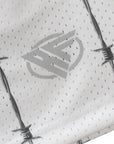 Close-up of RF-Wear Men's Reflective Logo Barbed Wire Shorts in White with RF logo