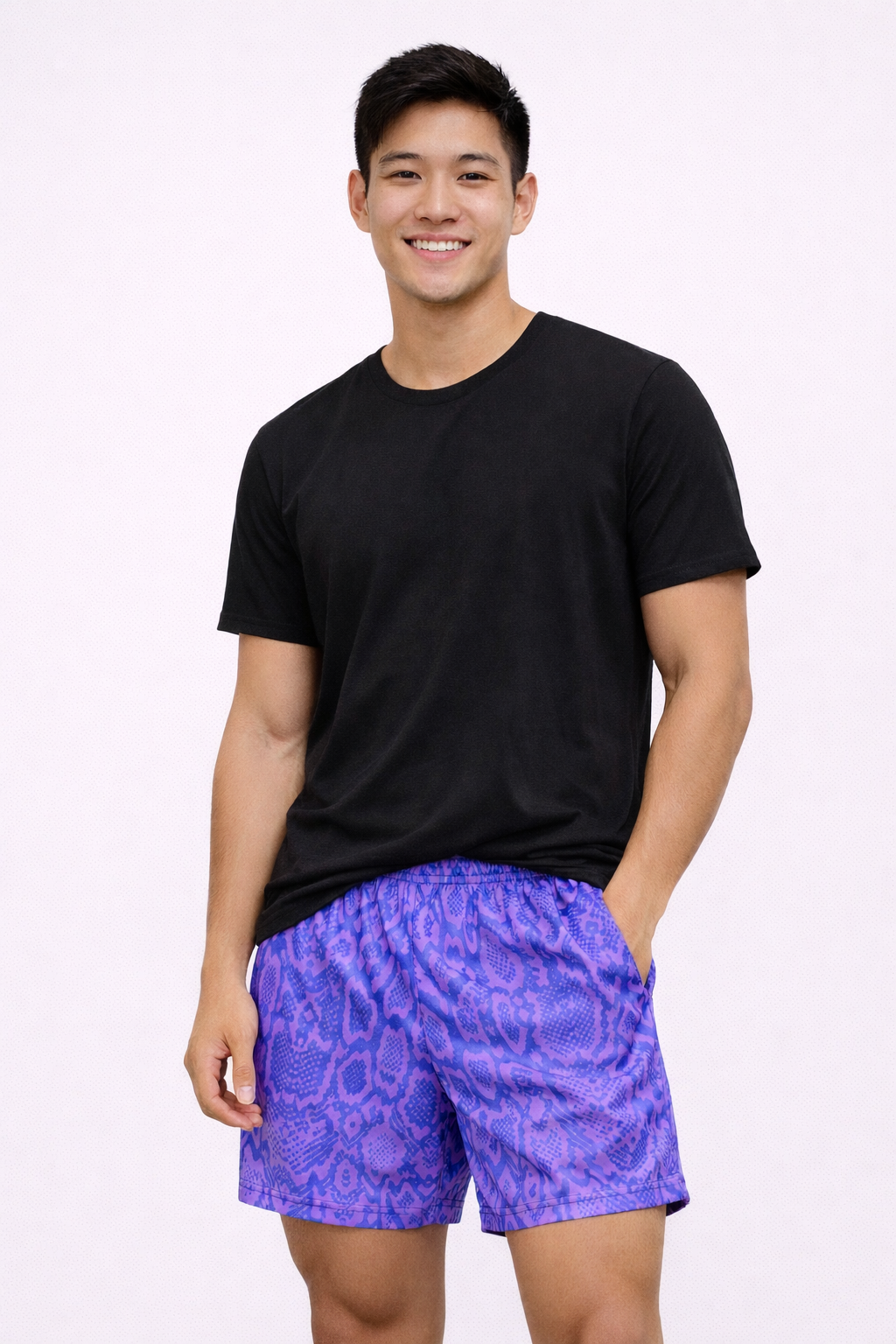 Man wearing a black t-shirt and RF-Wear Men's Snakeskin Shorts in Purple