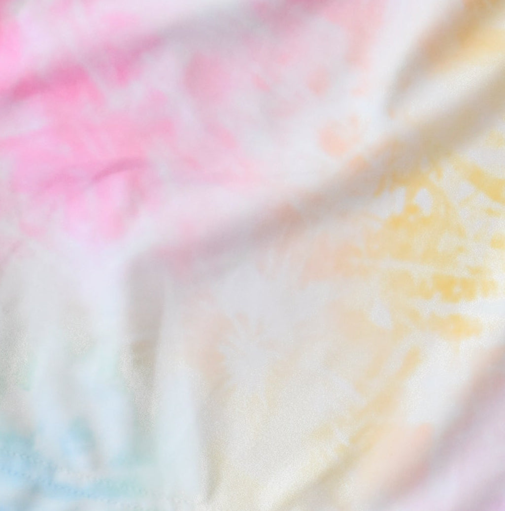 Pastel tie-dye pattern with pink, yellow, and blue colors.