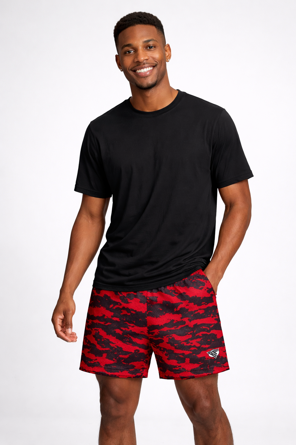 Man wearing a black t-shirt and RF-Wear Men's Mesh Tiger Camo Shorts in Red