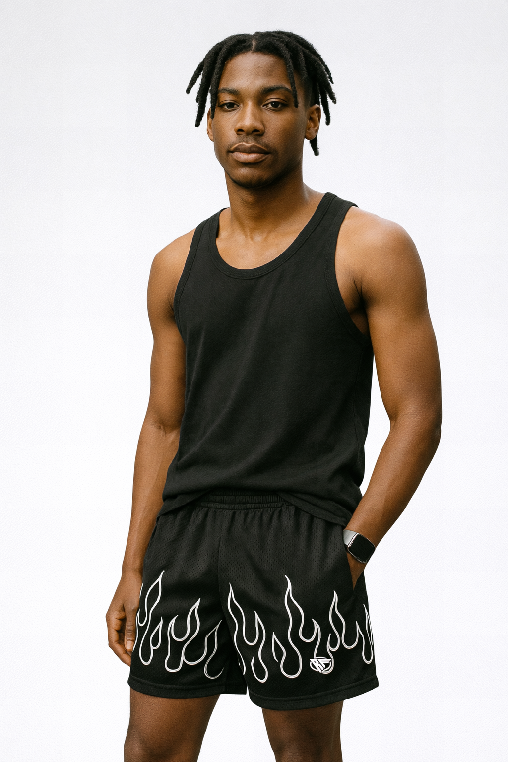 Man wearing a black tank top and RF-Wear Men's Mesh Fire Shorts in Black/White