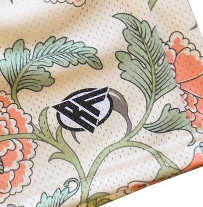 Decorative fabric with floral patterns and a brand logo on a beige background
